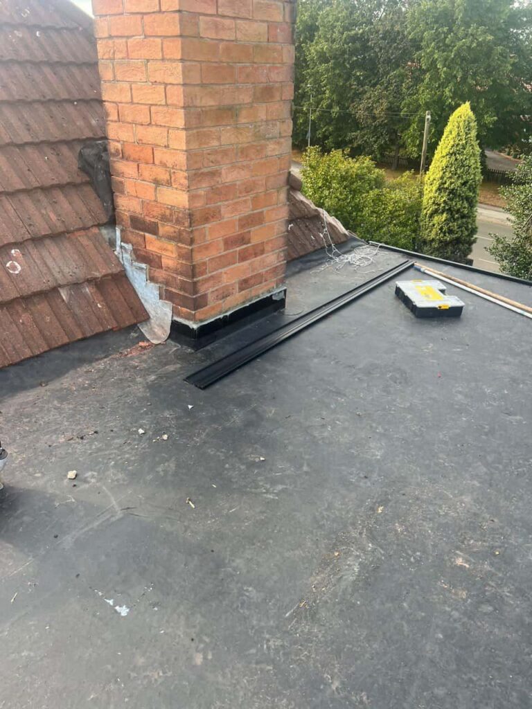 This is a photo of a flat roof which has just been repaired, there is also a chimney stack and some leadwork has also been dressed. Works carried out by Erith Roofing Repairs